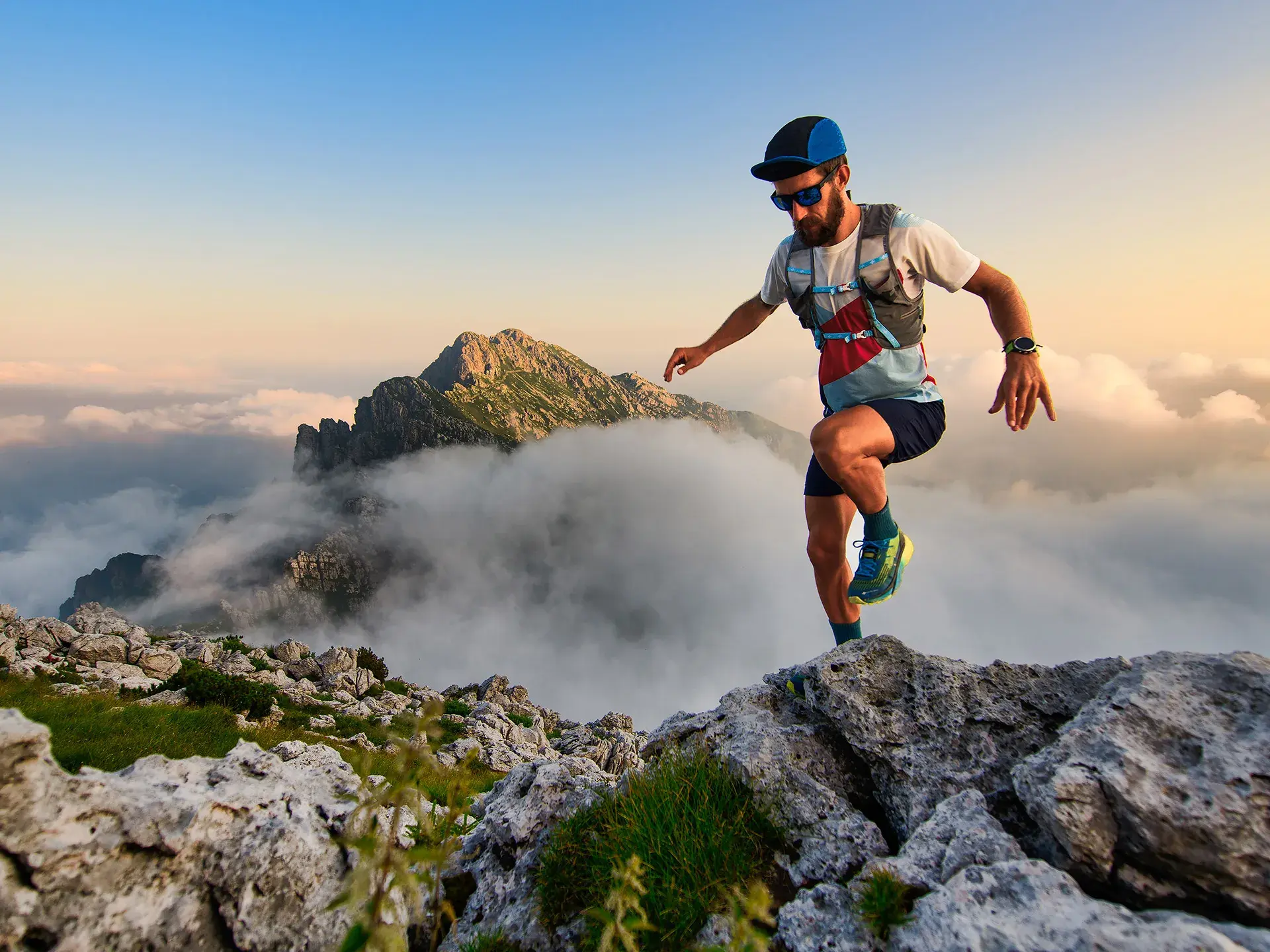 Homme pratiquant le trail en montagne dans un paysage alpin grandiose